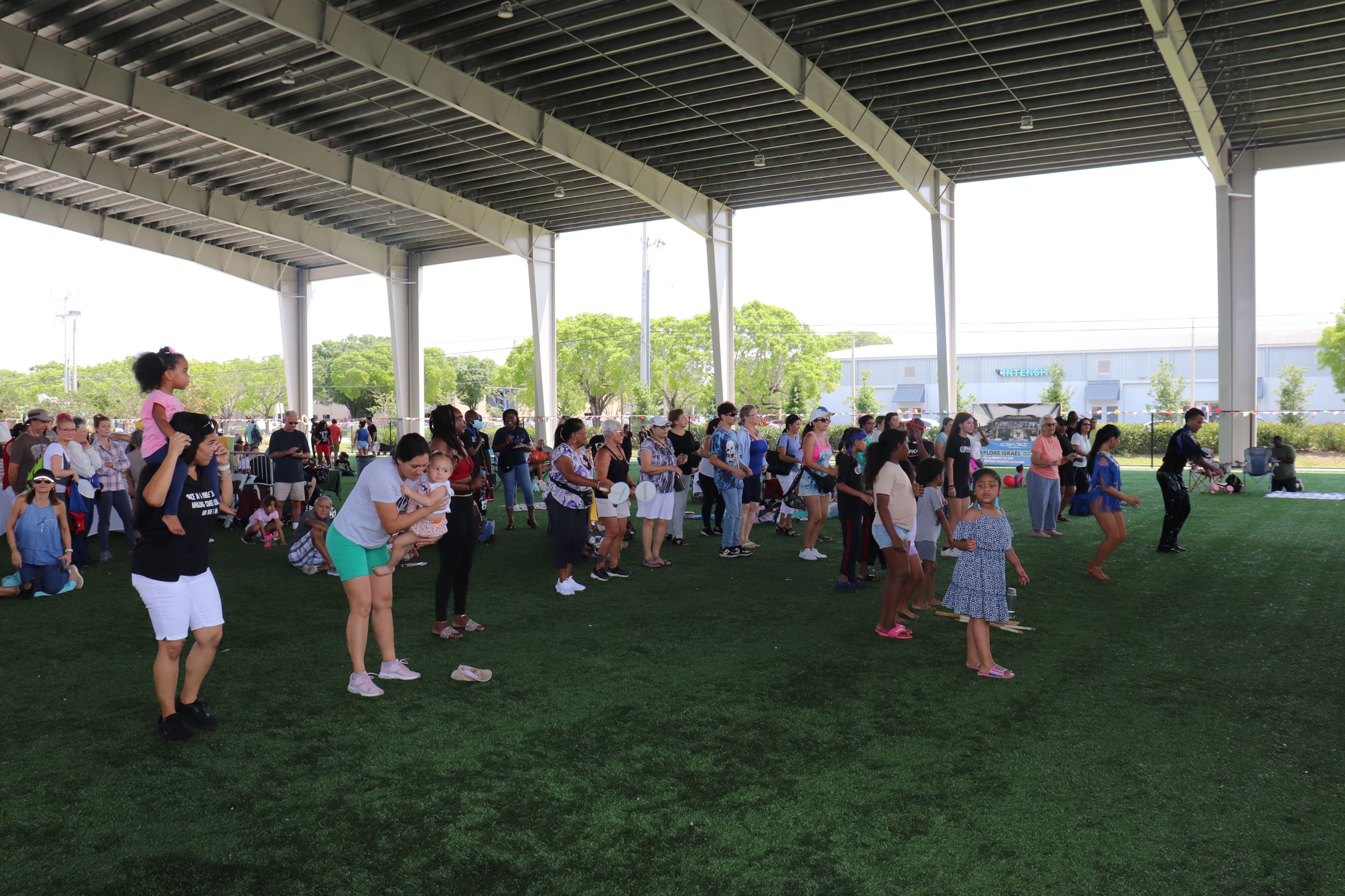 Image of group of people dancing together at event 